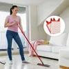 A woman is cleaning a wooden floor with a mop in a bright, modern living room. There is a sofa in the background. Náhled obrázku produktu