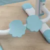 Close-up of the blue paw-shaped footrests and white frame of a child's desk and chair set. Produktbild-Vorschau