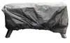 A black cover is draped over an outdoor oven, obscuring most of its details. The cover has a drawstring at the bottom, and the oven's legs are visible underneath. Podgląd zdjęcia produktu