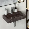 A close-up view of a wall-mounted marble sink with a faucet, soap dispenser, and toothbrush holder. Voir les images du produit