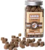 A jar of freeze-dried lamb treats for cats and dogs, with some treats spilled in front of the jar. Podgląd zdjęcia produktu