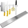 A set of kitchen knives and scissors are displayed on a magnetic strip, with a separate magnetic strip shown below. Anteprima dell’immagine prodotto