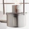 Close-up of an outdoor wall light fixture, showing the metal and glass components and a label with product specifications. Produktbild-Vorschau