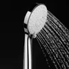A close-up shot of a shower head with water spraying from it against a black background. Produktbild-Vorschau