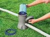 A person is shown assembling a pool filter pump on a grassy lawn. Produktbild-Vorschau