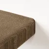A close-up view of a brown cardboard scratching board mounted on a white wall. Produktbild-Vorschau