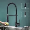 A black kitchen faucet is shown being used to wash an apple over a sink. Insets show different spray patterns. Produktbild-Vorschau