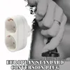 A hand is plugging a European standard conversion plug into an electrical outlet. The plug has two sockets. Produktbild-Vorschau