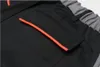 A close-up view of a black work pant pocket with orange trim. Produktbild-Vorschau