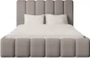A bed with a headboard and footboard, made of bouclé fabric, with white pillows and bedding. Produktbild-Vorschau