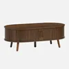 A wooden coffee table with ribbed detailing and two doors, presented against a plain background. Produktbild-Vorschau