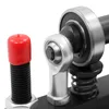 A close-up view of mechanical components, including a bearing, a rod end joint, a spring, and a threaded bolt with a red cap. Náhled obrázku produktu