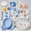 A collection of unassembled model kit pieces for a Sonic the Hedgehog character, likely Tails, laid out on a gray surface. Podgląd zdjęcia produktu