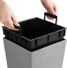 Hands are shown inserting a black plastic planter liner into a gray textured planter. Náhľad obrázku produktu