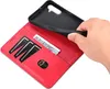 A hand is holding a black phone case over a red wallet-style phone case with card slots and a bill compartment. Produktbild-Vorschau