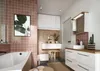 A modern bathroom with pink tiled walls, a white bathtub, a vanity with a wooden countertop, and various bathroom accessories. Produktbild-Vorschau