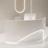A modern, curved reception desk in a minimalist setting. Produktbild-Vorschau
