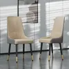 Two modern dining chairs are shown in a well-lit room with a painting on the wall. Podgląd zdjęcia produktu