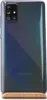 The back of a Samsung smartphone is shown, standing upright on a wooden stand. Podgląd zdjęcia produktu