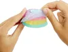 Hands holding a colorful, layered cake-shaped toy. Produktbild-Vorschau