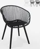 A black chair with a slatted back and seat, shown from the front on a white background. Three other chairs in different colors (white, grey, black) are visible in the background. Produktbild-Vorschau