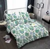 A bedroom scene with a bed dressed in green fern-patterned bedding, a bedside table with a lamp, and decorative items on the wall. Náhled obrázku produktu