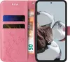 A pink flip phone case with floral and butterfly designs is shown open, revealing card slots and a banknote. A smartphone is inserted into the case. Produktbild-Vorschau