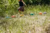 A child is playing on a set of colorful stepping stones in a grassy outdoor area. Voir les images du produit