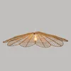 A pendant light with a woven, leaf-like shade. Produktbild-Vorschau