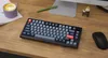 A keyboard, mouse, coffee cup, and pen are arranged on a wooden desk. Produktbild-Vorschau