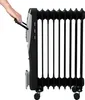 A hand is shown gripping the handle of a black and silver oil-filled radiator heater. Podgląd zdjęcia produktu