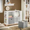 A child's room with a white storage unit filled with books and toys, a shelf above with artwork, and a rug on the floor. Podgląd zdjęcia produktu