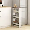 A narrow, multi-tiered shelf unit filled with jars of spices and other kitchen items, placed next to a white cabinet and a refrigerator in a kitchen setting. Produktbild-Vorschau