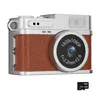A vintage-style digital camera with a brown leather-like finish and silver accents, shown from the front. A micro SD card is placed next to it. Produktbild-Vorschau