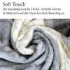 A close-up, swirled view of a soft, plush blanket with a gray and white patterned design. Produktbild-Vorschau