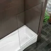 A white bathtub with a glass shower screen in a bathroom with dark tiled floors and brown tiled walls. Produktbild-Vorschau