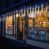A storefront decorated with Christmas lights and garlands. Náhled obrázku produktu