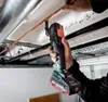 A person is using a Metabo multitool to cut a copper pipe. Náhľad obrázku produktu
