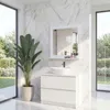A modern bathroom with a vanity, sink, and mirror, set against a backdrop of marble tiles and large windows overlooking a garden. Produktbild-Vorschau