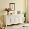 A white sideboard with drawers and doors, decorated with flowers and a cactus. Produktbild-Vorschau