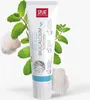 A tube of SPLAT Biocalcium toothpaste is shown in the center, surrounded by mint leaves and seashells. Produktbild-Vorschau
