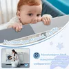 A baby biting on a crib rail with surrounding marketing graphics and a smaller inset image of a woman doing laundry. Voir les images du produit