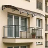 A balcony with a railing and a canopy over the windows. Náhled obrázku produktu