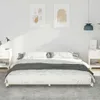 A bedroom scene with a bed in the center, flanked by nightstands and artwork on the wall. Produktbild-Vorschau