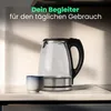 A glass electric kettle and a small cup are placed on a countertop in a kitchen setting. Produktbild-Vorschau