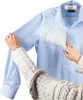 A person is using a handheld garment steamer on a blue shirt. Náhled obrázku produktu