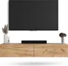 A TV stand with a TV mounted above it, and decorative items on the stand. Produktbild-Vorschau