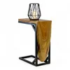 A wooden side table with a black metal frame and a candle holder on top, presented against a white background. Voir les images du produit