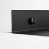 A close-up of a black metal shelf with a small black knob on it, set against a white background. Náhľad obrázku produktu