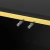 A close-up view of two small gray plastic pegs attached to a gold strip, which is part of a black furniture item. Anteprima dell’immagine prodotto